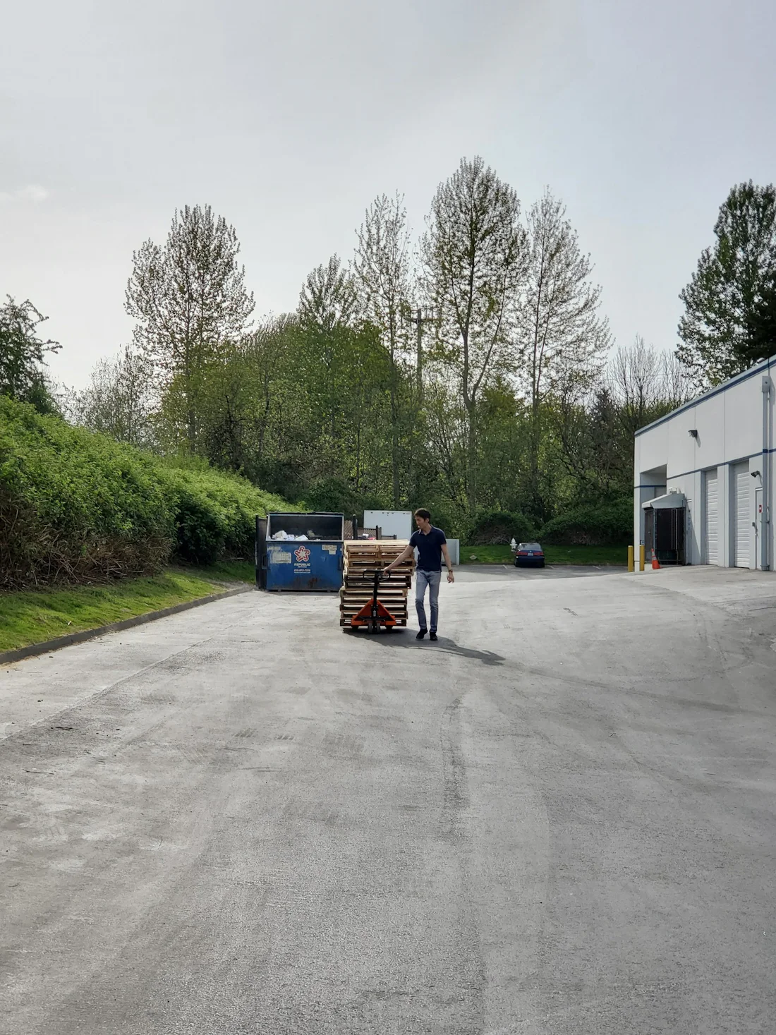 Palletized freight being moved on a pallet jack at a loading area